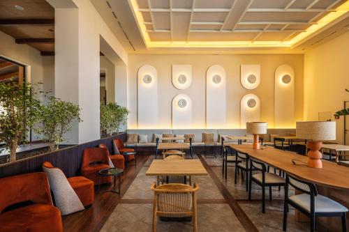 a dining room with tables and chairs and portraits on the wall at Barceló Tenerife Royal Level in San Miguel de Abona