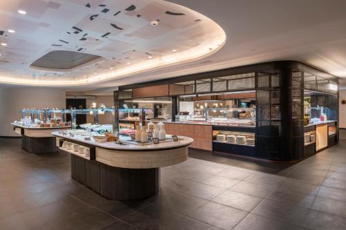 a restaurant with several counters in a room at Barceló Tenerife Royal Level in San Miguel de Abona