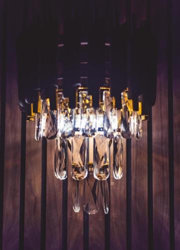 a chandelier with lights in a room at Impossible Motel in York