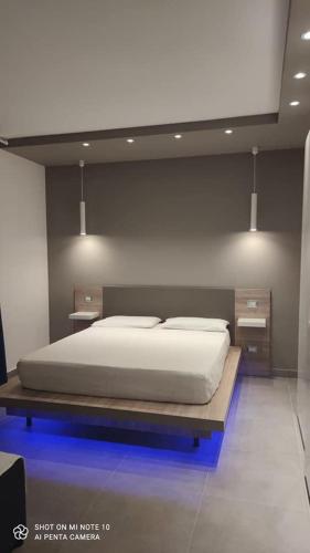a bedroom with a bed and two night stands at Villa Russo Apartment in Trecastagni