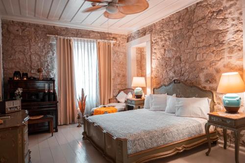 a bedroom with a bed and a ceiling fan at Hoşça kal Alaçatı in Alaçatı