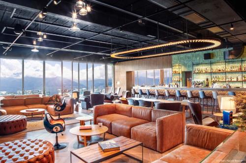 a lobby with leather couches and a bar at Villars Palace in Villars-sur-Ollon
