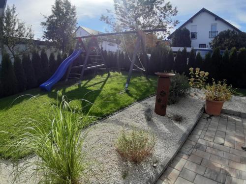 a backyard with a playground with a slide at Ferienwohnung Ludwigshöhe in Kempten