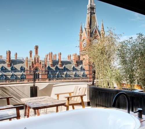 a bathroom with a tub and a view of a clock tower at The Standard London in London