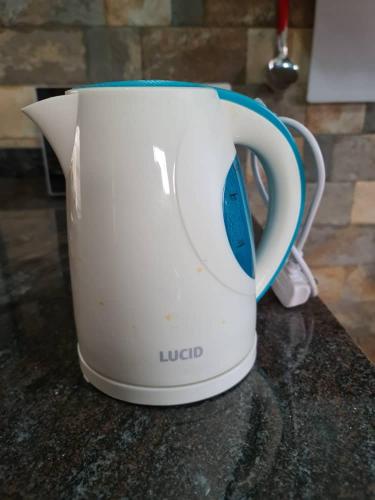 a white toaster sitting on top of a counter at Unia fancy flats 3 bed room apartment- Flat 2 in Kampala