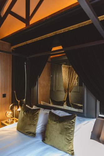 a bedroom with a large bed with a black headboard at Impossible Motel in York