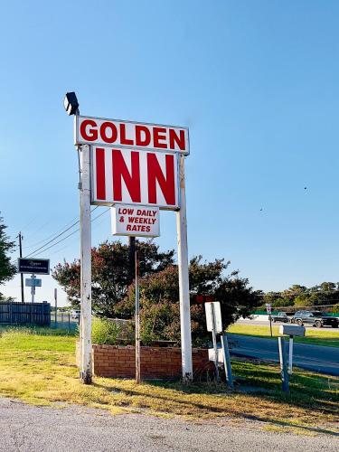 a sign for a golden inn on the side of a road at Golden Inn in Seagoville