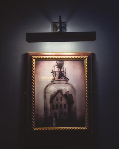 a picture of a house in a jar on a wall at Impossible Motel in York
