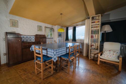 a kitchen with a dining room table and chairs at Fevri apartment in Madonna di Campiglio