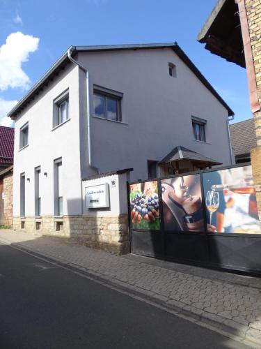 a white building with posters on the side of it at Gästehaus Schattemorellsche in Fürfeld