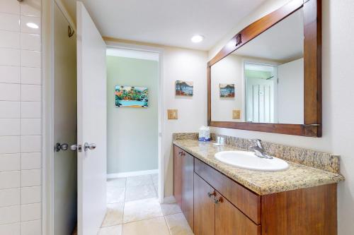 a bathroom with a sink and a mirror at Islander on the Beach 315 in Kapaa