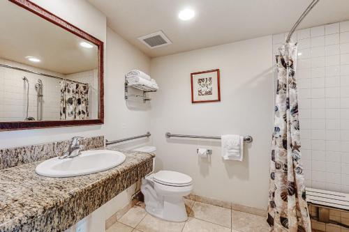 a bathroom with a sink and a toilet at Islander on the Beach 101 in Kapaa