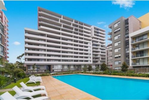 an image of an apartment complex with a swimming pool at Garden View of Macquarie Park Paradise in Sydney