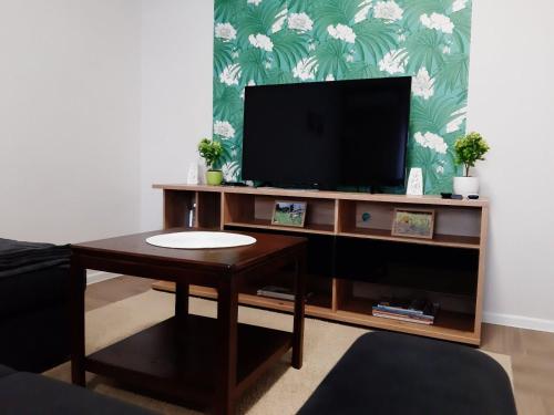 a living room with a tv and a coffee table at Apartments Manna Palic in Palić