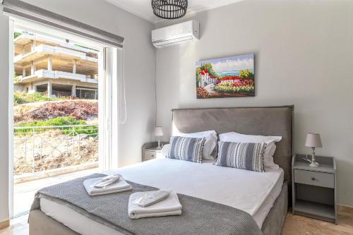 um quarto com uma cama grande e uma janela em Pallas em Keratea