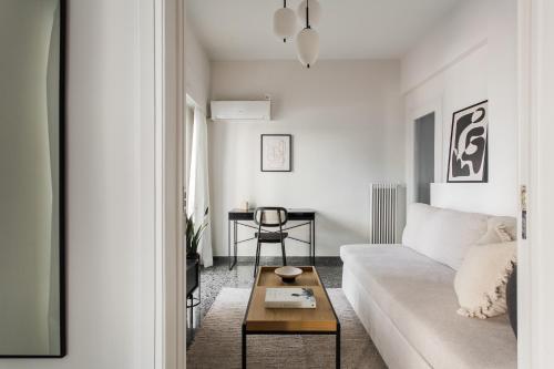 a living room with a white couch and a table at Glorious 1BR Apartment in Athens by UPSTREET in Athens