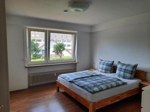 a bedroom with a bed and a window at FeWo mit Terrasse für 4-5 Personen mit Schwimmbad + Sauna in Bad Grund