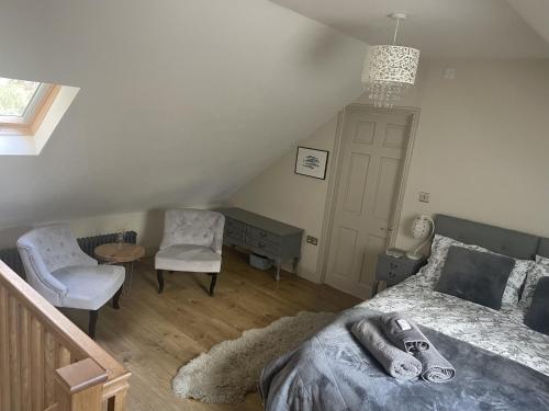 Postel nebo postele na pokoji v ubytování Cotswold Lodge