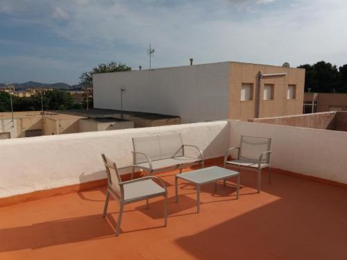 two chairs and a table on top of a roof at Casa Bounty in Los Nietos