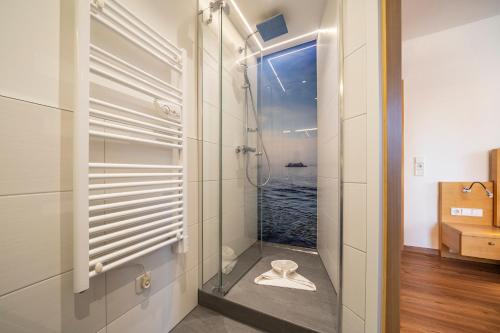 a bathroom with a shower with a view of the ocean at Gästehaus am Bodensee in Immenstaad am Bodensee
