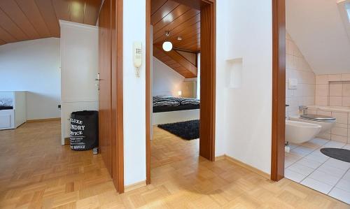 a room with a bathroom with a toilet and a bed at BB City Appartements in Böblingen