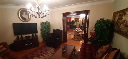 a living room with a couch and a tv and a mirror at الاسكندريه - سموحه in Alexandria