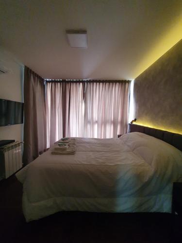 a bedroom with a white bed and a window at LOCADOR Nueva Cordoba 3C in Cordoba
