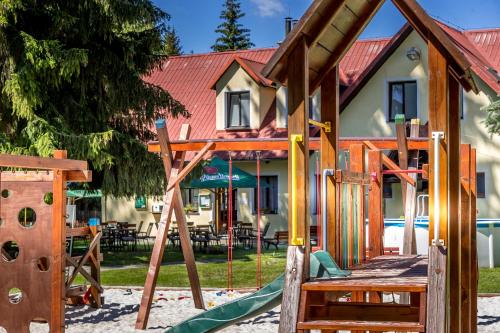 a playground in front of a house at Penzion U Skály in Kytlice