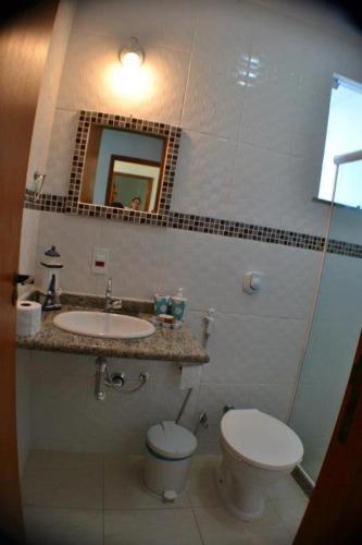 a bathroom with a toilet and a sink at Pousada da Gigoia - Barra da Tijuca in Rio de Janeiro