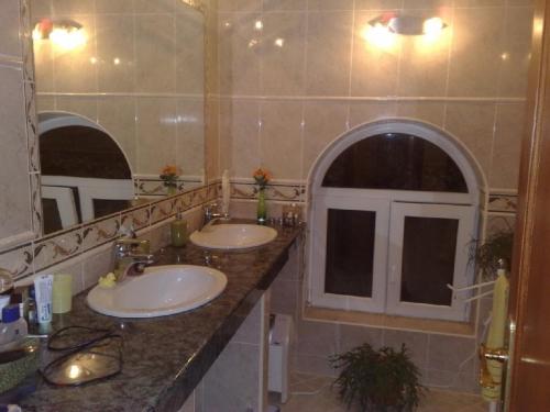 a bathroom with two sinks and a large mirror at Villa in Funtana with private Tenniscourt (3418) in Funtana
