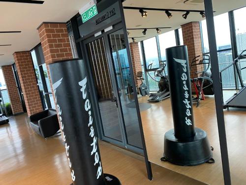 a gym with two black and white signs in a room at Ceylonz Suite in Kuala Lumpur
