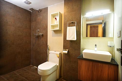 a bathroom with a toilet and a sink and a mirror at Capital Boutique Hotel in Kathmandu