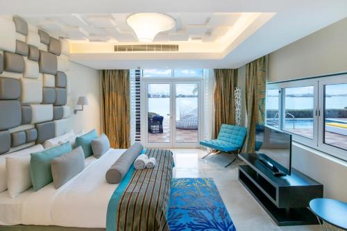 a living room with a large white couch and a chair at FAM Living - Sarai Beach Villas - Palm Jumeirah - Families Only in Dubai