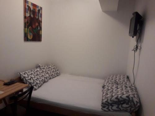 a small bedroom with a bed and a desk at Jasmin in Belgrade