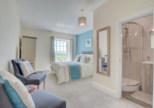 a bedroom with a bed and a shower and a bathroom at Trefnant Hall in Welshpool