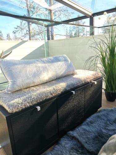 a bench with two pillows on top of it at Levi Secret Igloo Revontuli in Levi