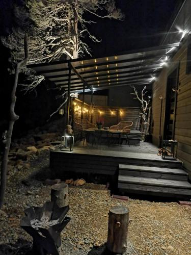 a patio at night with a table and lights at Levi Secret Igloo Revontuli in Levi