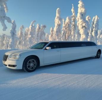 a white limousine parked on a snow covered road at Levi Secret Igloo Revontuli in Levi