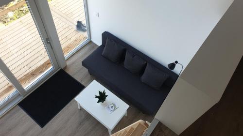 an overhead view of a living room with a couch and a table at Cottages by the Sea in Sørvágur