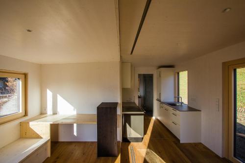 a small kitchen in a house with wooden floors at Biohotel Grafenast in Pill