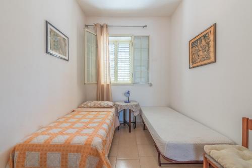 a bedroom with a bed and a window and a table at Casa Nico in Augusta