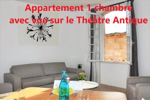 a living room with a couch and a table at Holiday in Arles -Appartement du Théâtre Antique in Arles