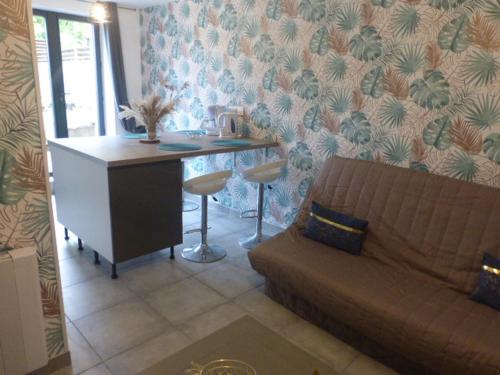 a living room with a couch and a desk at Au Champ Fleuri in Bracieux