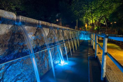 a water fountain at night with blue lights at Rio Quente Resorts - Eco Chalés in Rio Quente