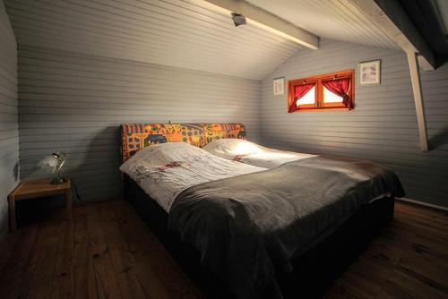 a bedroom with a large bed with a window at la cache des relles in Xonrupt-Longemer