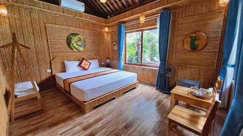 a bedroom with a bed in a wooden room at Tam Coc Amanda Villas in Ninh Binh