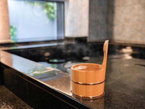 an orange cup sitting on top of a kitchen counter at Super Hotel Premier Ikebukuro Natural Hot Spring in Tokyo