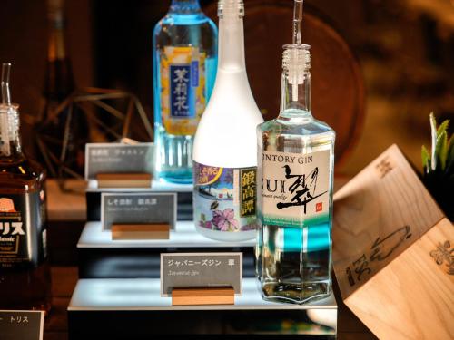 two bottles of alcohol sitting on a table at Super Hotel Premier Ikebukuro Natural Hot Spring in Tokyo