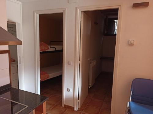 a room with a door leading to a bedroom at Aula Natura La Salle - Cal Cerdanyola in Bagá