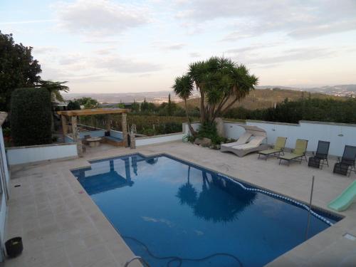 a swimming pool with a view of a house at Casal de S.Romão do Meio in Guimarães